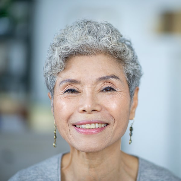 A woman is happily smiling thumb